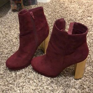 Ankle high maroon heels with a gold patterned heel